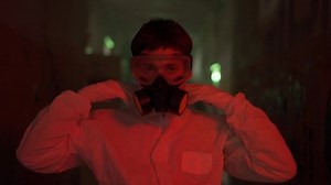 Red smoke shot worker put respirator and protection hood on his face