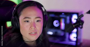 Gaming, asian and woman live streaming with microphone for online video game community in Korea. Content creator, gamer and streamer sharing thoughts on game for subscription, esports and fans.
