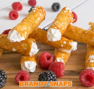 Contrarary to the name, Brandy Snaps do not contain any brandy. They are crispy, caramel lace tubes filled with creamy whipped cream. A popular British dessert for the holidays. Recipe > https://culinaryginger.com/brandy-snaps/ Pin > https://www.pinterest.com/pin/56787645294305566/ | Culinary Ginger - Authentic Recipes, Honest Ingredients