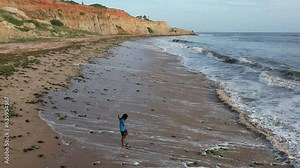 Luanda, Angola - August 17, 2023: Drone view filming beach waves in slow motion