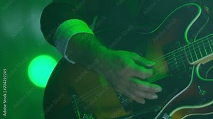Close up of man playing a guitar at a concert 4K, event entertainment, audience excitement, musician live performance atmosphere, concert, music festival, crowd, party.