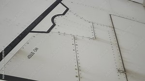 No step letter sign on an airplane wing during the flight at high altitude