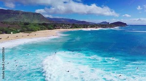 Surfers ride ocean waves at Makaha surf spot in Hawaii