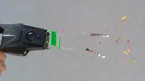 A taser is fired at a human target and video footage slows the action down to 28,000 fps so you can see the full impact in detail as it penetrates the skin. | The Slow Mo Guys