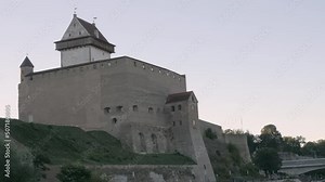 Narva.Estonia-August 11.2020: The fortress Narva castle on the border town in Estonia with the Russia on the other side of the border.geology shot.zoom out