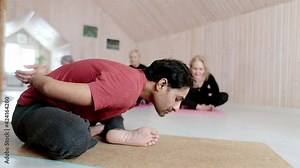 Three elderly women practice yoga exercises with an instructor at home.