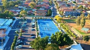 Aerial Drone panoramic view of Sydney NSW Australia city Skyline and looking down on all suburban houses and streets parks and roads