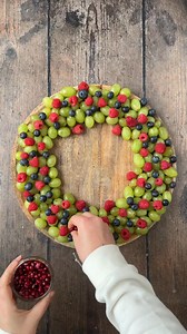 This Christmas Fruit Wreath is so stunning, but ridiculously easy to make. A beautiful centerpiece on a festive party food table and it balances out all those more indulgent foods. Ready in just 5 minutes too! | Hungry Healthy Happy - Easy Recipes