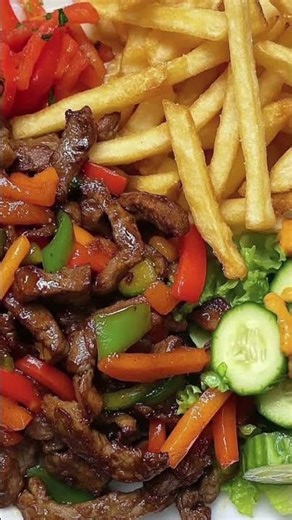 Sizzling Pepper Beef Stir-Fry with Golden Fries & Mango Salad 🥩🍟🥗This mouthwatering plate brings🖤