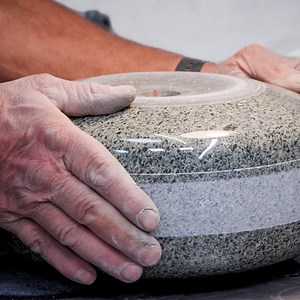 A single curling stone certified for the Olympics costs over $600. That makes a full set of 16 stones worth $9,600. Since 2006, every stone used in the Olympic Winter Games has come from Kays of Scotland. The company has produced curling stones since 1851. But making these stones isn't easy. For every stone it makes, Kays uses granite from one tiny island off the coast of Scotland called Ailsa Craig. By combining Ailsa Craig's common green and blue hone granites, Kays produces the only stones al