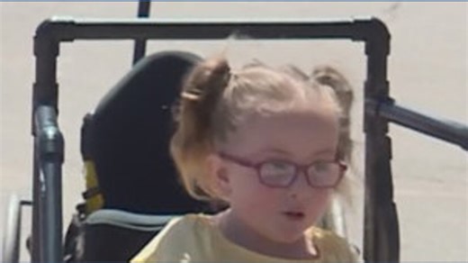 Girl with spina bifida gifted adaptive toy car