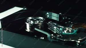 The inside of the hard drive. Disk with the head of data reading. Computer technologies of information storage. Server racks consist of hard disks. Cloud storage, information flow. Hard drive spindle