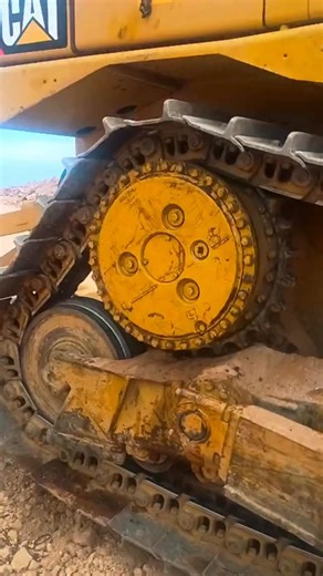 Putting this CAT dozer’s undercarriage through its paces! It’s crucial to ensure every component is performing flawlessly for maximum efficiency and safety on the job site. Here are the key undercarriage parts you can see working together: * **Drive Sprocket:** The large, toothed wheel at the rear that engages with the track chain to drive the machine. * **Track Chain (Track Link Assembly):** The interconnected links that form the main structure of the track. * **Track Shoes (Grousers):** The in