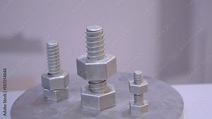 Object printed on 3D printer. Object in shape of bolt with nut printed on a 3D printer from metal powder close-up. New modern additive technologies for printing 3D printer from metal. SLM. Prototyping