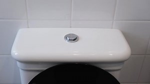 Finger of a woman hand presses the toilet flush button, close up video
