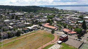Cinematic 4K drone trucking footage of the downtown Edmonds commercial area, Kingston ferry terminal waterfront marina, near Seattle in Western Washington, Pacific Northwest, in Snohomish County