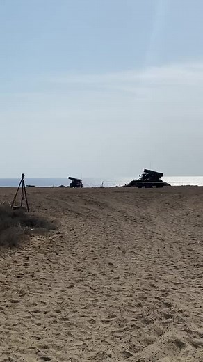 Military Artillery Gun Firing on Sandy Beach