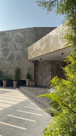 Aman Verma Architects (AVA) on Instagram: "JAGAT RESORT This facade is a sophisticated work of contemporary architecture that masterfully blends bold geometric forms with intricate, technologically advanced surface detailing. Its design can be understood by examining its key components: the perforated screen system, the interaction of materiality and light, and its overall massing and form. The Parametric Perforated Screen The most dominant feature is the building’s outer “skin,” a decorative sc