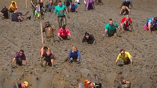 Hundreds crawl through riverbed in iconic UK mud race