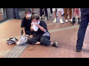 一中年婦人和少女坐在地上，婦人嘔吐，情緒激動。