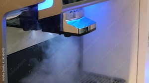 Rinsing or self-cleaning the self-service coffee machine. The coffee machine releases steam.