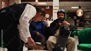 Person paying with credit card for coffee, using pos terminal transaction to buy hot beverage in lounge area. Friends waiting to go skiing at alpine mountain lodging with extreme slopes.