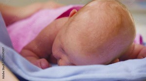 Newborns first strength display, portrait of a baby tenderly holding his head up