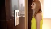 Beautiful young woman in yellow dress waiting for an elevator....