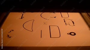 Powder 3D printer printing models from white powder polyamide close-up. Black outlines of objects are formed on white surface under action of thermal print head. New modern 3D printing technology