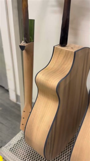 Two Myrtlewood guitars in the Breedlove Custom Shop finish department, waiting for their high-gloss shine. | Breedlove Guitars