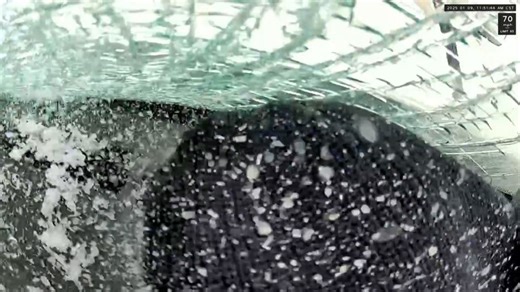 Ice flies off a moving car and smashes into a passing truck’s windshield