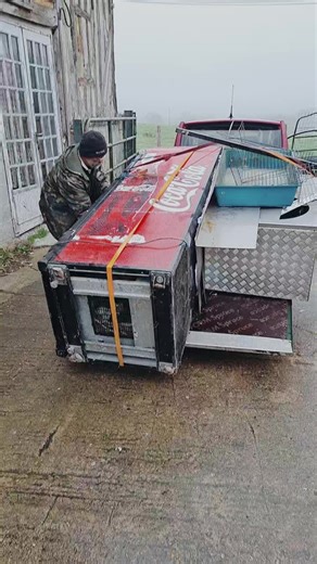 Loading a Coca-Cola Cooler onto a Pickup Truck