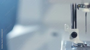 Sewing needle of modern sewing machine. Sewing machine needle work process. Sewing needle working. Household equipment. Working electric sewing machine