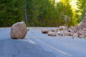 Man takes pleasure filming cars being damaged by a large rock placed in driveway