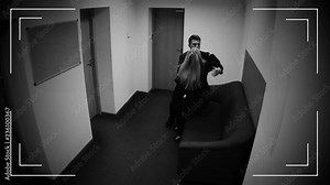 Two co-workers kissing in office, romantic relationship at work, CCTV camera