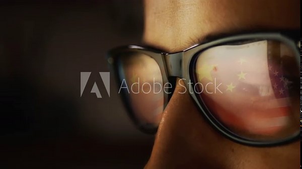 In the reflection of the glasses on a male face, an Internet search engine and the reflection of the Chinese flag turning into the US flag. Cg footage