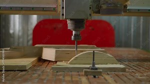 Automated CNC machine processing plywood with precision, detailed view of the cutter in action