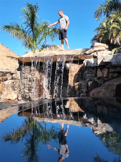 Epic Backyard Paradise with Grotto and Tiki Huts