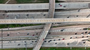 Traffic in USA. Modern highway interstate freeway system. Top down aerial of many lanes of cars. Gas prices and carbon theme.