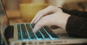 Girl typing text on a laptop