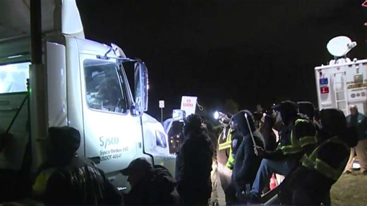 Striking union workers confront truck drivers at Sysco warehouse in Plympton