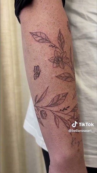Beautiful Vine Arm Wrap Tattoo with Daffodils