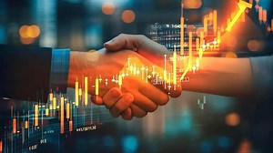 Download Two people shaking hands in front of a stock market chart for free