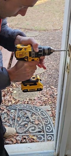 a guy installing a deadbolt lock