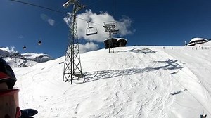 Ride on the chairlift. Skiing in the Alps.. Stabilized footage.