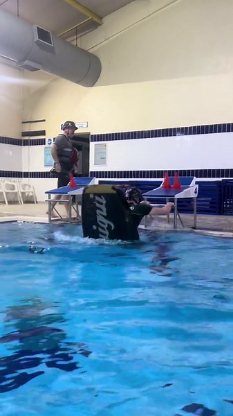 Practicing kayak flips in the pool on a cold river day