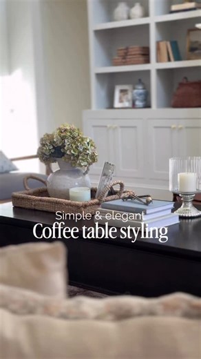 Rachel | Home Design, DIY & Decor on Instagram: "Simple & elevated coffee table styling ✨ Comment DETAILS below if you’d like the links to what I used here—and be sure to follow along for more home styling inspiration. 🫶 When I style a coffee table, I like to think in 3–4 simple zones. One grouping is anchored with a tray, another one or two are built with a stack of books, and the last spot is perfect for a pair of hurricanes or taper candles—something with a bit of height. Somewhere within th