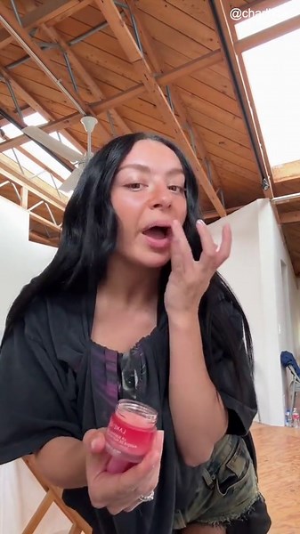 Singer and songwriter Charli XCX poses with some beauty products