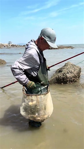 An elderly fisherman crabbing along the coast; effective crabbing methods