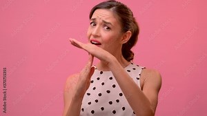 Studio shot of sad dissatisfied tired frustrated woman shows timeout gesture, needs stop, asks time for rest after hard work, demonstrates break hand sign, over pink background. Body language concept